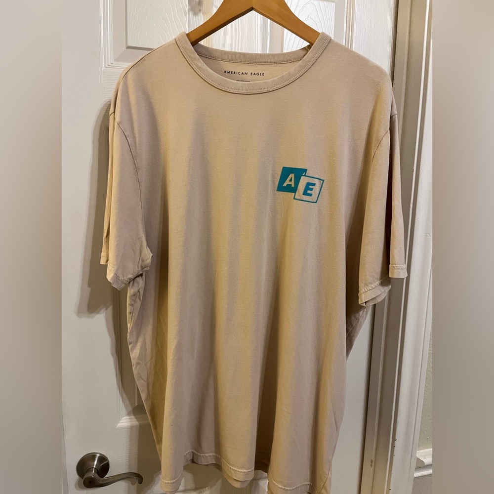 American Eagle Outfitters Beige Tee with Teal Logo